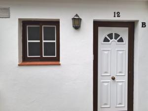 a white house with a white door and a window at Casa del Cu bano B- Biosphere Reserve in Santa Cruz de Tenerife