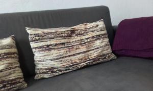 a couch with two pillows on top of it at Casa del Cu bano B- Biosphere Reserve in Santa Cruz de Tenerife