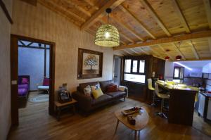a living room with a couch and a table at El Balcon de Justina - Sierra de Gata in Torre de Don Miguel