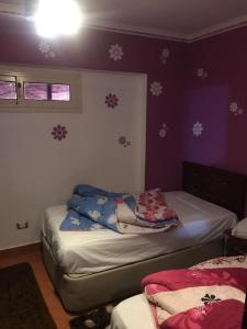 a bedroom with two beds with snow covered walls at Chalets at Pyramids Porto Sokhna by Easy Rent 2 in Ain Sokhna