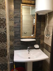 a bathroom with a sink and a mirror at Chalets at Pyramids Porto Sokhna by Easy Rent 2 in Ain Sokhna