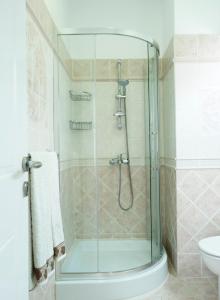 a shower with a glass door in a bathroom at Haraki Beach Mediterranean Retreat in Haraki