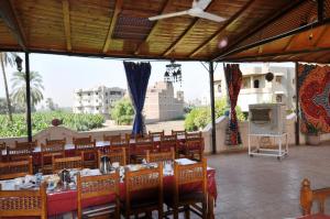 a restaurant with a table and chairs with a view at El Nakhil Hotel in Luxor