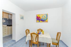 a kitchen and dining room with a table and chairs at Apartment Vitaic in Supetar