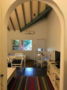 a living room with an archway and a dining room at Club del Campo El Faro Studio 15 in Carmelo