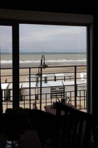 a room with a view of the beach and the ocean at Hotel Les Mouettes in Wenduine