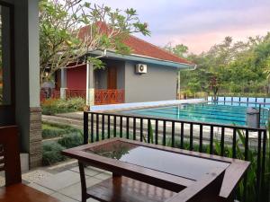 a view from the balcony of a house with a swimming pool at Mandalawangi Hotel Syariah in Tasikmalaya