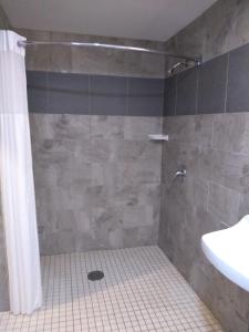 a bathroom with a shower and a sink at Days Inn by Wyndham Alva in Alva