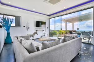 a living room with a large couch and a large window at Villa Azur, 4 Bedrooms, Ocean View in Chaweng