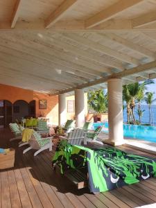 una terraza con tumbonas y una piscina en Villa Los Gorgones, en Las Galeras