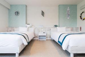 מיטה או מיטות בחדר ב-Alaise De Bale Ishigaki