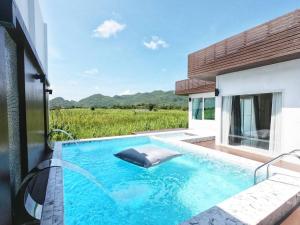 a swimming pool in the middle of a house at The Vista Pool Villa in Kanchanaburi City