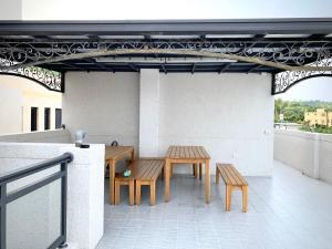 two tables and benches on a rooftop patio at Coral Island in Xiaoliuqiu
