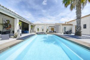 a swimming pool in the backyard of a house at Mas Sainte Marie in Aigues-Mortes