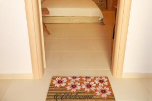 a small rug on the floor of a room with a bed at BLUE PHAISTOS APARTMENTS No1 in Moírai