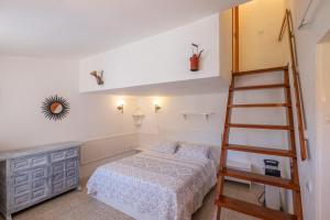 a bedroom with a bed and a ladder at Villa Bouganvilla in Tossa de Mar +21 photos