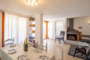 a living room with a table and a fireplace at Villa Bouganvilla in Tossa de Mar