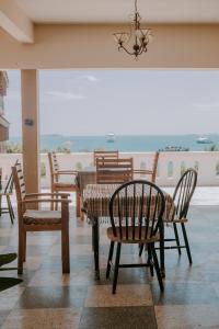 a restaurant with chairs and a table with a view at Abuso Inn in Zanzibar City