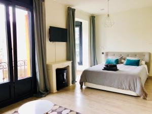sypialnia z łóżkiem z niebieskimi poduszkami i kominkiem w obiekcie Espectacular suite con vistas a la ría w mieście Bilbao