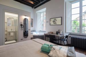 a bedroom with a bed and a bathroom with a sink at Piccolo Principe Affittacamere in Monterosso al Mare