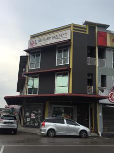 a gray car parked in front of a building at BENUTHOMESTAY in Johor Bahru
