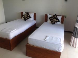 Letto o letti in una camera di Sunstar Nilaveli