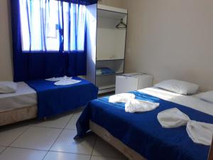 Łóżko lub łóżka w pokoju w obiekcie Hotel Divino Pai Eterno