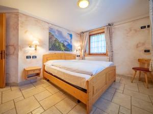 a bedroom with a large bed in a room at Baita Stebline - AlpineEscape in Livigno