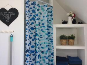 a shower curtain with a blue and white at Marielyst B&B - Apartments in Næstved