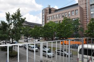 a city street with cars parked in a parking lot at Hotel-Pension Asta in Munich