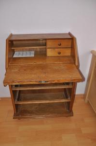 a wooden desk sitting on top of a wooden floor at Hotel-Pension Asta in Munich