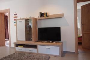 a living room with a entertainment center with a flat screen tv at Ferienlounge in Salzhemmendorf