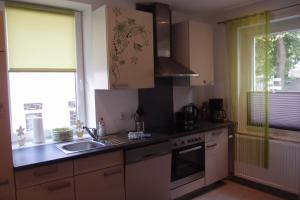 a kitchen with a sink and a stove top oven at Ferienlounge in Salzhemmendorf +1 photo