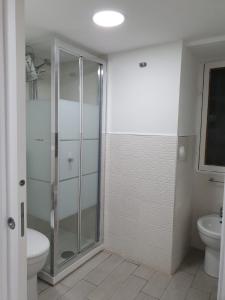 uma casa de banho com uma cabina de duche em vidro e um WC. em Casetta fiori di loto em Palermo