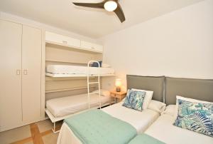 A bed or beds in a room at 70sqm private terrace in front of the sea & 107sqm brand new apartment