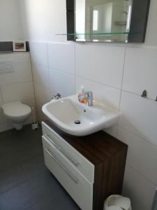 a bathroom with a sink and a toilet at Wohnung Lemkenhafen in Fehmarn