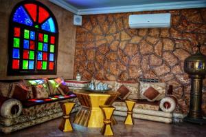 a living room with a couch and a stained glass window at Riad les jardins Mabrouk in Taroudant