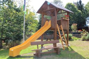a playground with a slide and a gazebo at Ferienwohnung Caroline in Hemfurth-Edersee