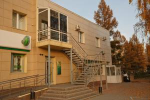 a building with a spiral staircase on the side of it at OVB Hostel in Ob