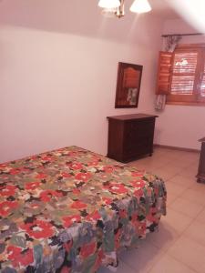 a bedroom with a bed and a dresser in it at Apartamentos Cerro Negro - Los Magalites in Capileira