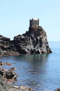 a castle on an island in the ocean at Pretty Home in Acireale