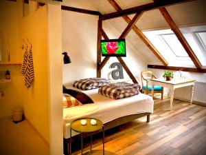 a bedroom with a bed with a tv on the wall at Høloftet bb in Esbjerg