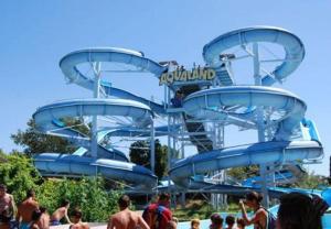 a blue water slide at a water park at studio 4 pers terrasse climatisation parking privé 300m plage in Cap d'Agde