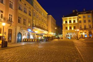 a cobblestone street in a city at night at Apartment on Lychakivska in Lviv