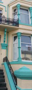 a building with blue columns and stairs on it at The Riviera Hotel in Blackpool