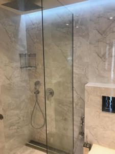 a shower with a glass door in a bathroom at Riverside apart in Blagoevgrad +19 photos