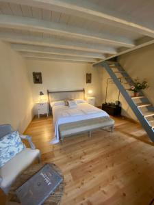 a large bedroom with a bed and a staircase at Antica Casa Fenaroli in Iseo
