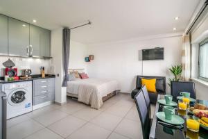 a kitchen and a bedroom with a bed and a table at ImpervillaStudio - Vilamoura City Centre in Quarteira