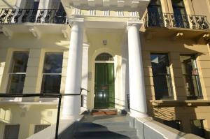 a large white house with a green door at Notting Hill Sleeps 5 in London