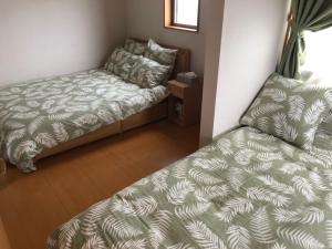 Katil atau katil-katil dalam bilik di Ocean Villa Okinoerabu